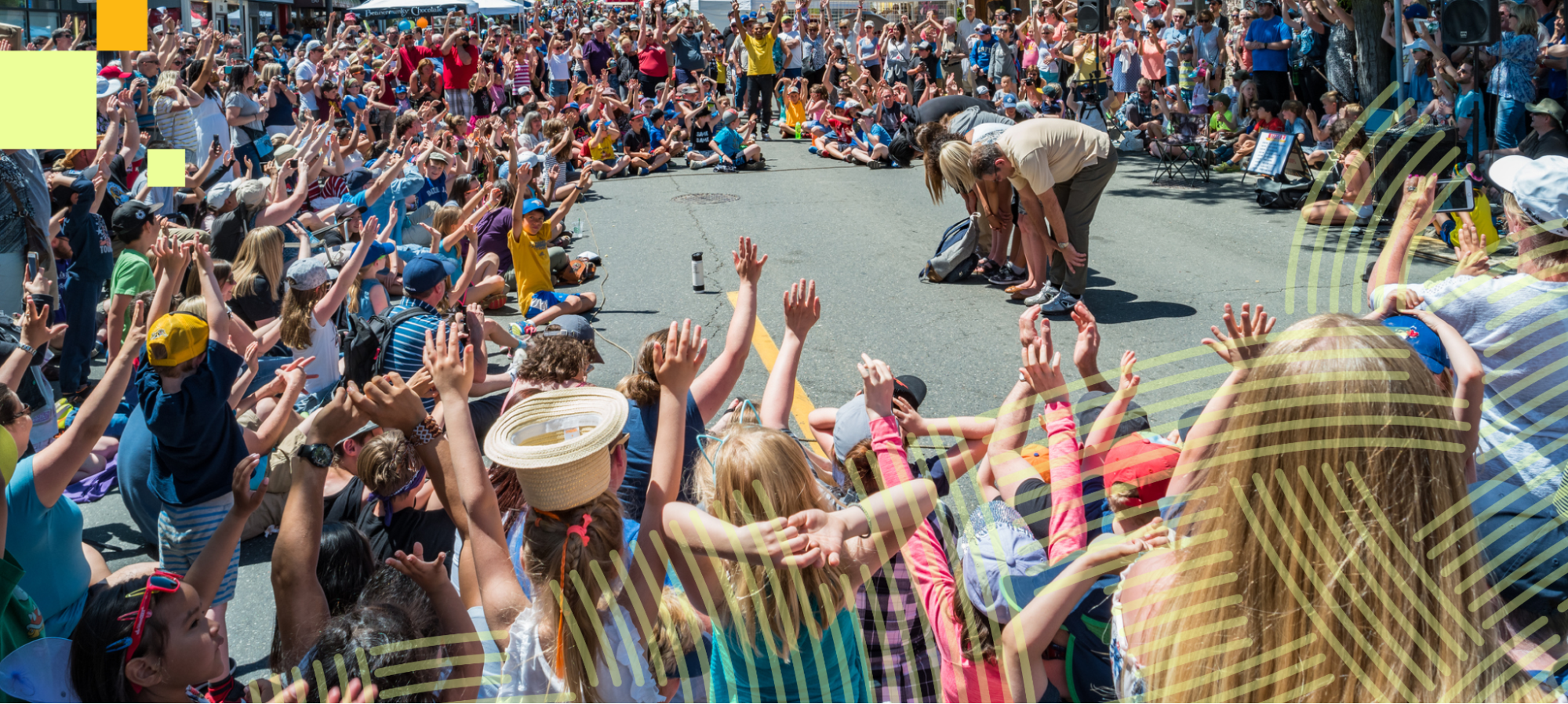 A large crowd gathers outdoors to celebrate 120 years of Taber’s growth, community, and heart, with people cheering and raising their hands in excitement.